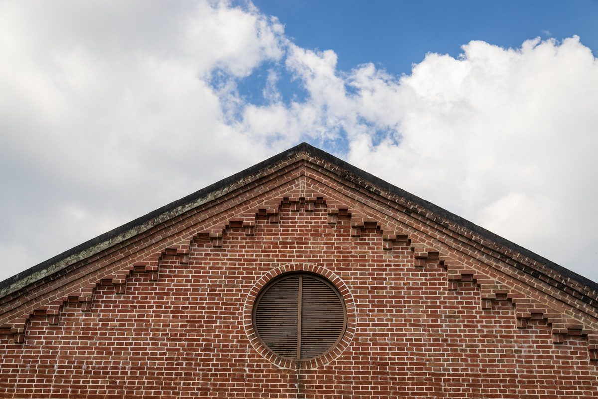 Brick gable end with a round louvered attic vent